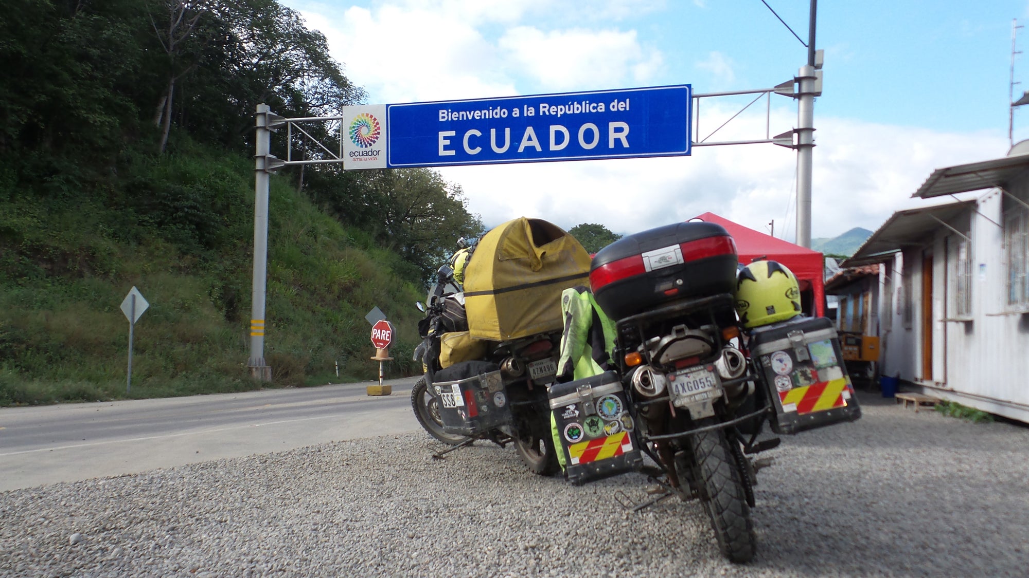 The Pack Track travelled north from Peru in to Ecuador. The motorbikes and Pillion Pooch pictured here at the border.