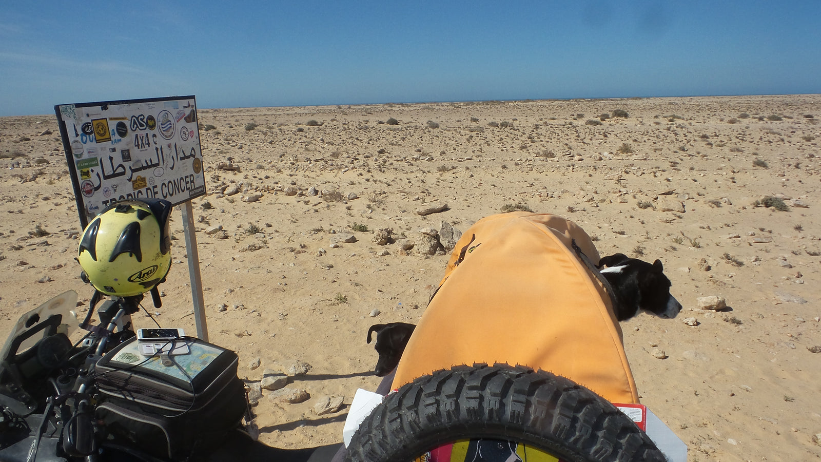 The Pack Track crossing the Tropic of Cancer in Western Sahara, Africa. Weeti and Shadow riding together in their Pillion Pooch.