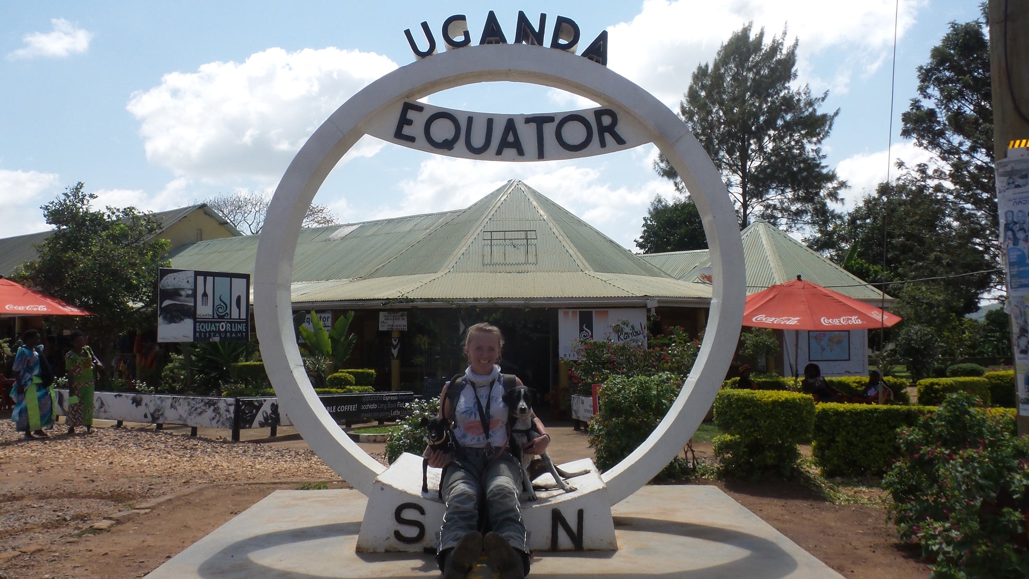 Janell, Weeti and Shadow enjoying a photo opportunity in Uganda with yet another overland equator crossing.