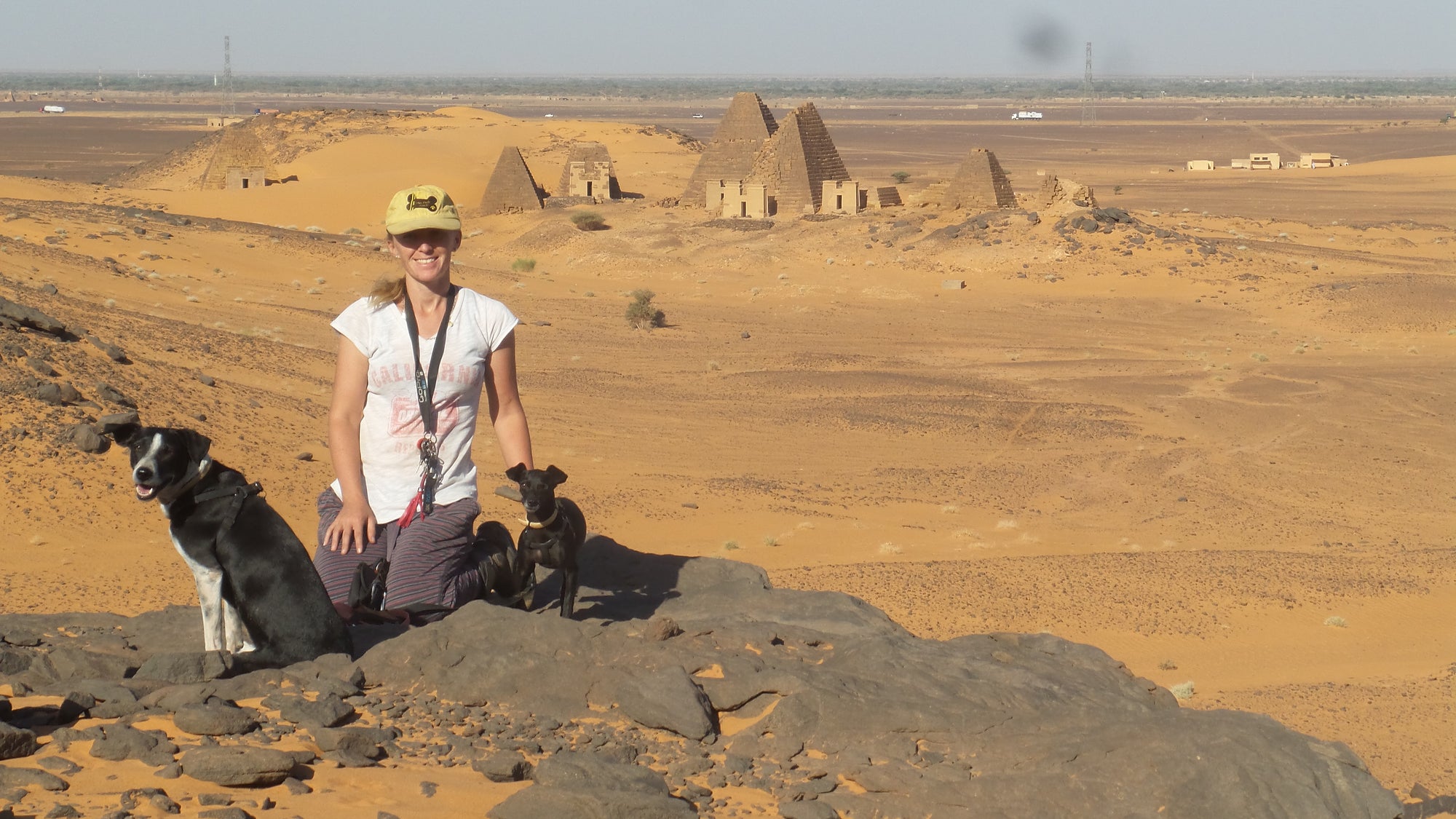 Sudan has many pyramid sites on the side of the highway. The Pack Track wild camped just near this site in the desert. Janell, Weeti and Shadow pictured here.