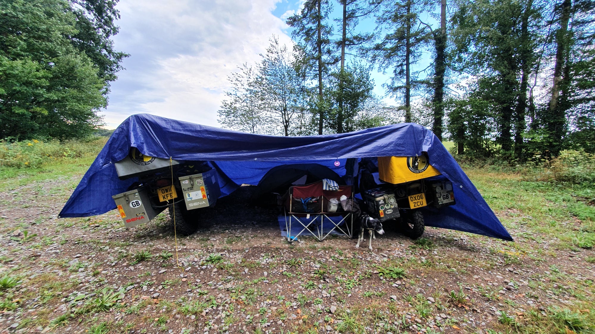 We recently introduced a giant tarpaulin which covers the motorbikes and our tent. The height of the Pillion Pooch's mean we can walk around underneath and stay dry.